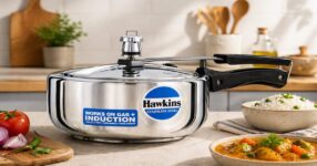 Stainless steel pressure cooker with food.